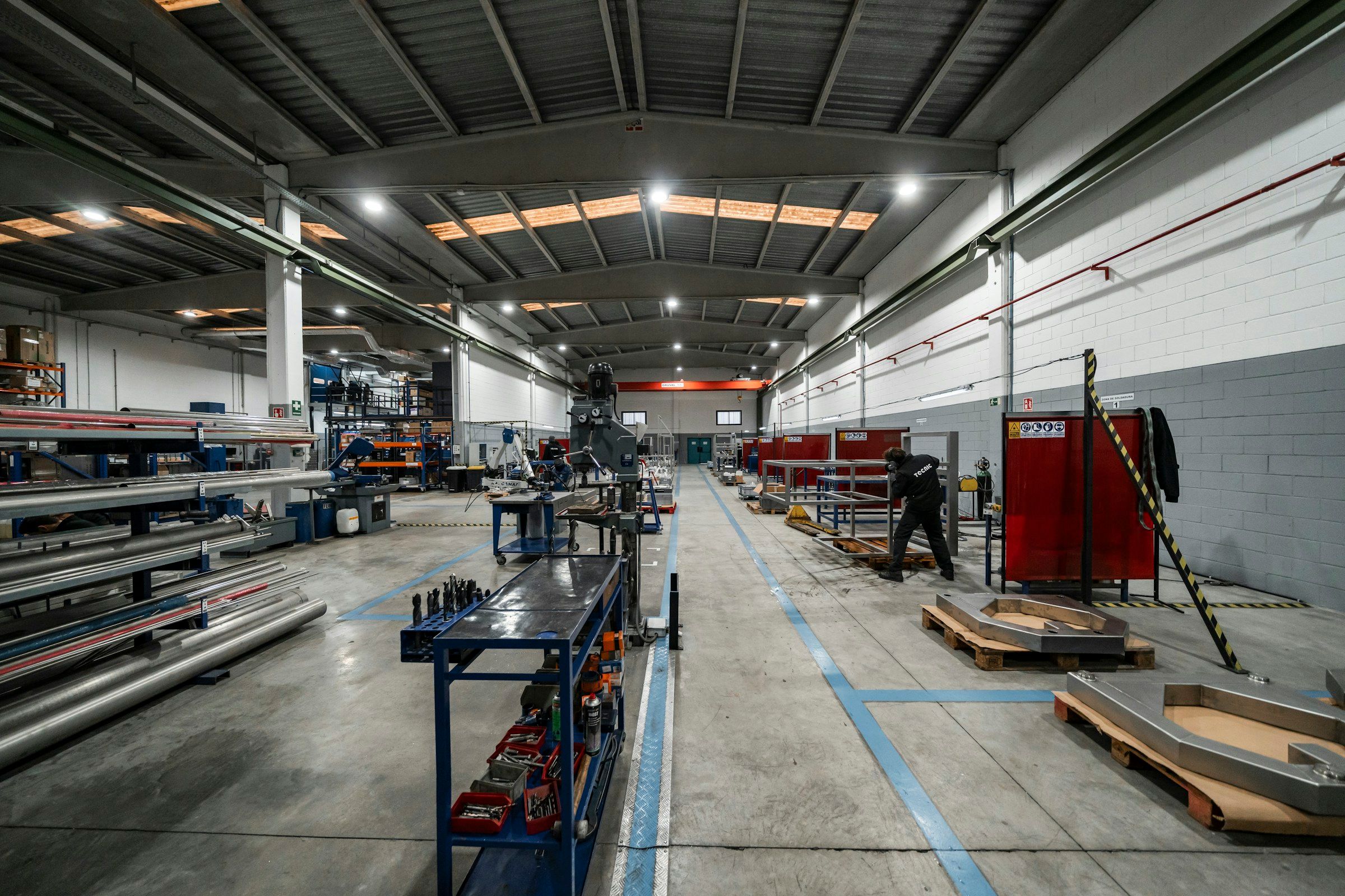 Industrial workshop interior with technician working at a fabrication station
