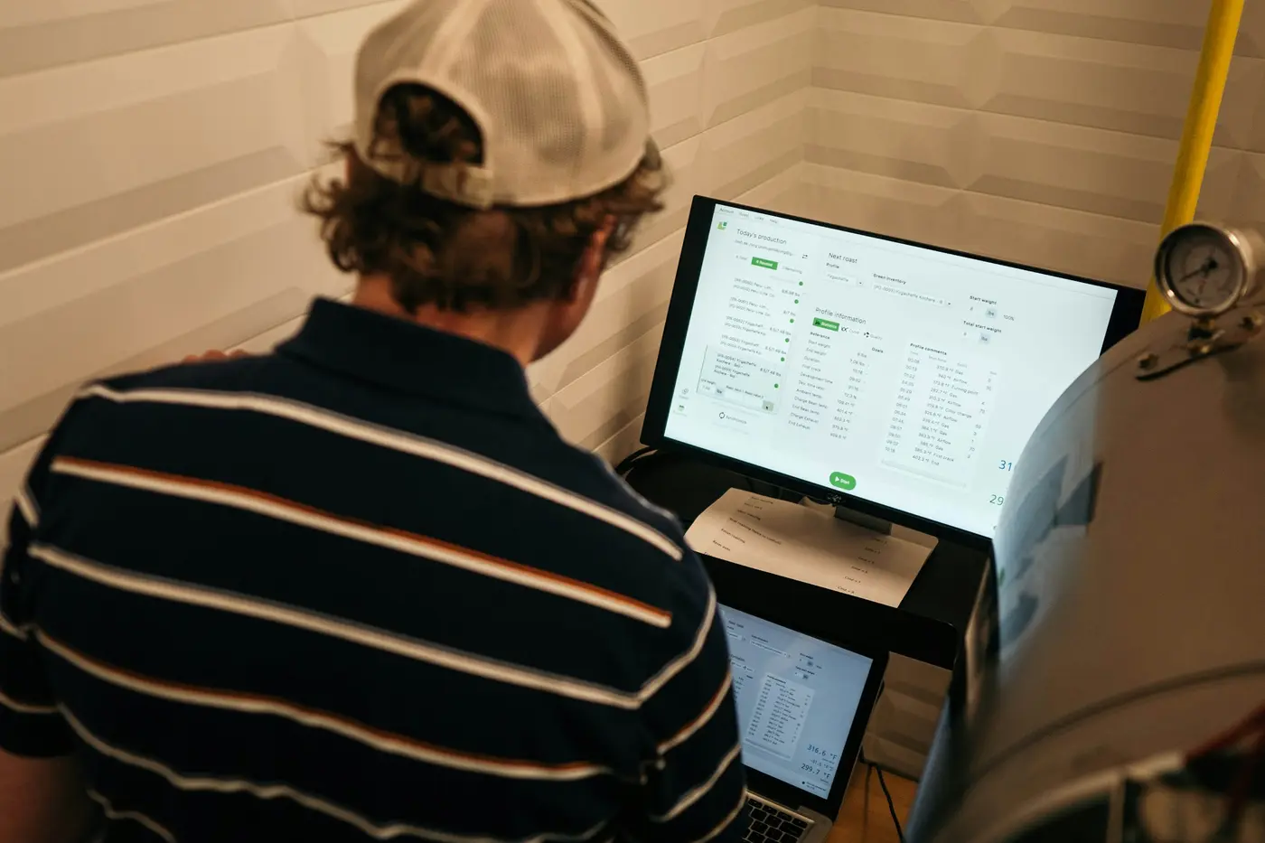 Operator working at an industrial HMI monitor on the factory floor